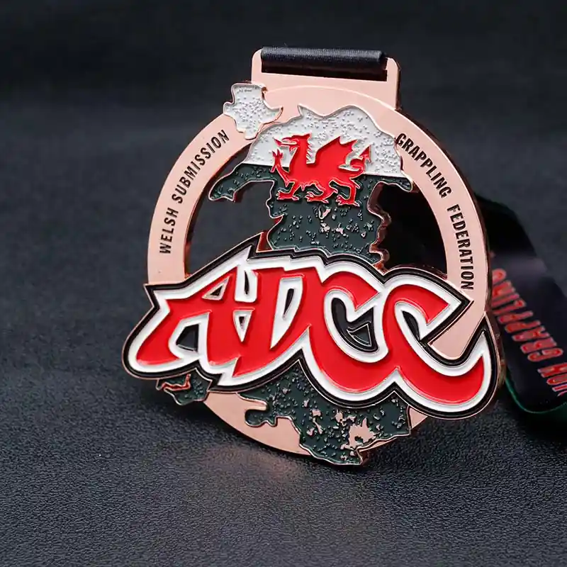 A custom ADCC wrestling medal featuring a detailed map design, red dragon emblem, and bold red ADCC logo, displayed on a dark background.