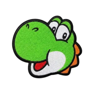 A colorful embroidered cartoon dinosaur patch with a green face, big expressive eyes, a white snout, and orange spikes, outlined in black and isolated on a white background.