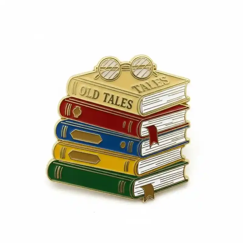 An enamel pin featuring a stack of colorful books labeled “Old Tales” with a pair of glasses on top, designed in a vintage style.