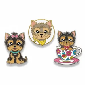 A set of three cute Yorkshire Terrier dog pins, including one with a pink bow, one with a yellow bandana, and one sitting in a floral teacup.