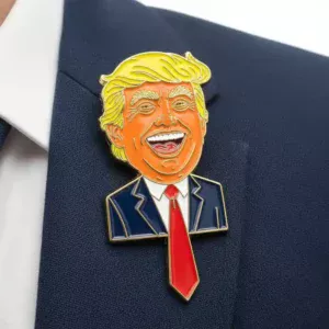 Custom soft enamel lapel pin with a detailed cartoon face, featuring blue enamel skin and yellow hair on a navy blazer.