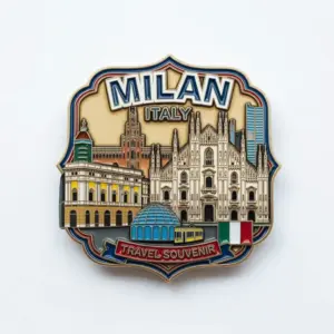 A detailed enamel badge showing Milan Cathedral, historic buildings, and Italian flag elements with Milan Italy travel souvenir text.