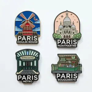 A set of Paris souvenir pins including Moulin Rouge windmill, Montmartre basilica, metro entrance, and a bouquiniste book stall design.