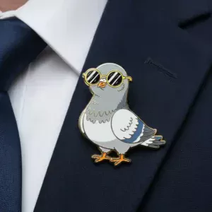 A cartoon-style pigeon with sunglasses enamel pin attached to a dark blue suit jacket.