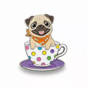 A cute pug with an orange bone-patterned bandana sitting in a white teacup decorated with colorful polka dots, placed on a purple glittery saucer.