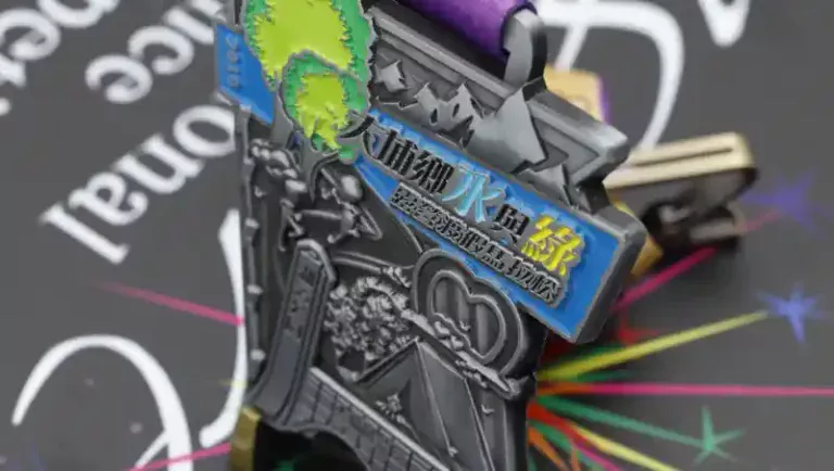 Close-up of a custom 3D metal marathon medal featuring detailed embossed elements, blue enamel banner with text, and attached purple ribbon.