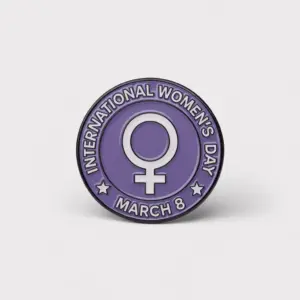 Purple enamel pin with feminist symbol and text International Women's Day March 8 in circular design.
