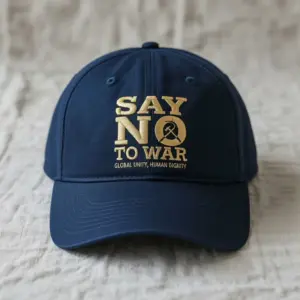 Navy blue cap with gold embroidery reading Say No to War Global Unity Human Dignity.