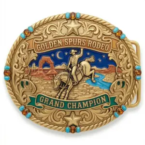 Detailed western buckle with cowboy riding horse at night desert landscape and golden spurs rodeo grand champion text.