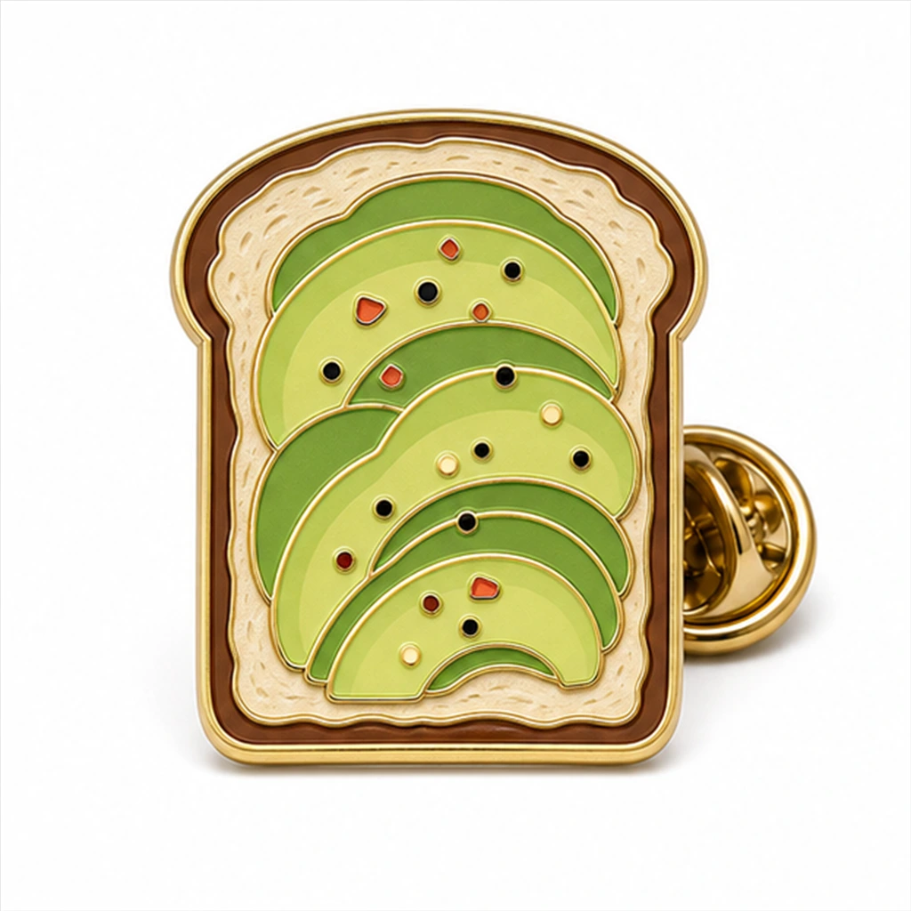 Custom avocado toast slice soft enamel pin with raised metal outlines and butterfly clutch on a white background.
