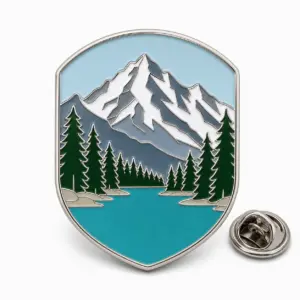 Custom Banff mountain lake soft enamel pin with silver outlines and butterfly clutch on a white background.