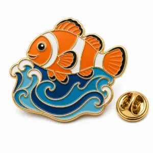 Clownfish wave soft enamel badge with attached blue waves, orange fish, gold dividers, and butterfly clutch.