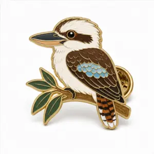 Custom kookaburra bird soft enamel pin with raised metal outlines and butterfly clutch on a white background.