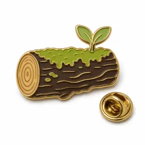 Log-shaped mossy enamel badge with sprout leaves, gold metal dividers, and butterfly clutch on white background.