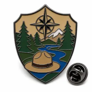 Custom park ranger compass crest soft enamel pin with raised metal outlines and butterfly clutch on a white background.