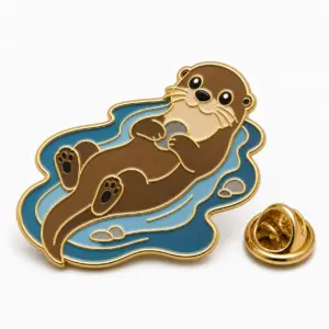 River otter soft enamel badge with otter swimming in blue water, gold outline, and butterfly clutch.