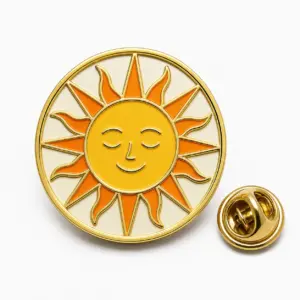 Round celestial sun enamel badge with calm face, orange rays, gold dividers, cream background, and butterfly clutch.