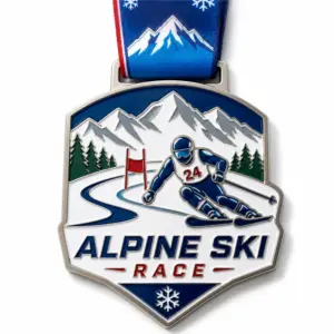 Shield gate racer Alpine Ski Race Medal soft enamel medal with raised silver outlines, snowy mountains, pine trees, red slalom gate, number 24 skier, blue neck ribbon, and white background.