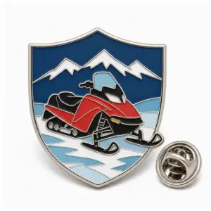 Custom snowmobile icy shield soft enamel pin with raised metal outlines and butterfly clutch on a white background.