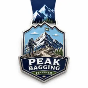 Detailed mountain hiker Peak Bagging Medal soft enamel medal with raised silver outlines, backpack hiker, snowy peak, winding summit trail, pine trees, ribbon loop, and mountain neck ribbon on a white background.
