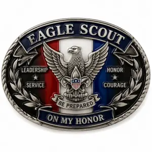 Eagle Scout on my honor belt buckle with raised silver eagle, fleur de lis shield, red white and blue enamel panels, leadership service honor courage text, and white background.