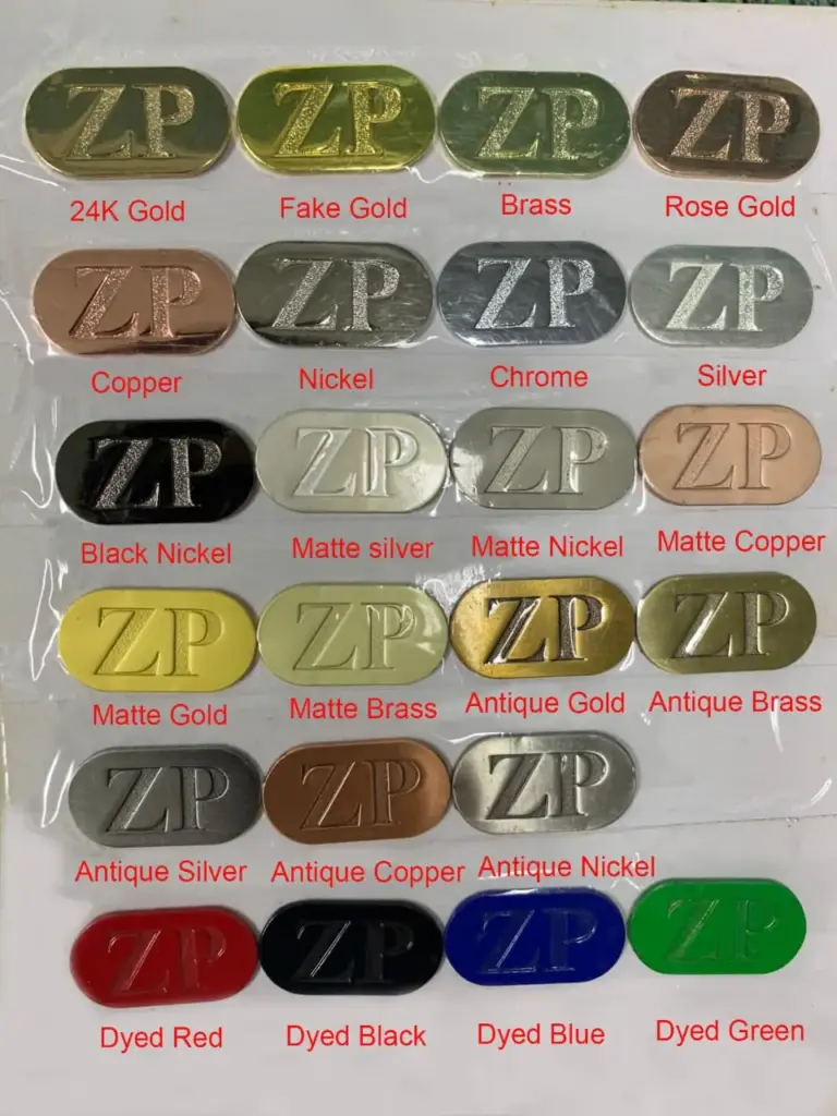 A metal electroplating color sample chart displaying various surface finishes including 24K gold, fake gold, brass, rose gold, copper, nickel, chrome, silver, matte finishes, antique finishes, and dyed colors for custom metal products.